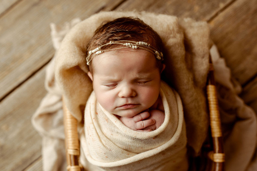 Joanna's daughter Lily as a newborn, swaddled and sleeping