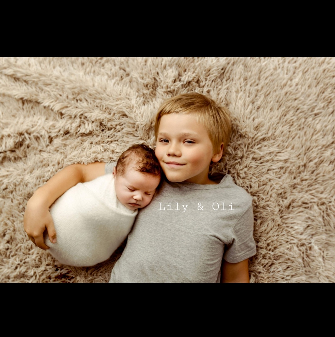 Joanna's children, Oli and his newborn baby sister Lily, lying together