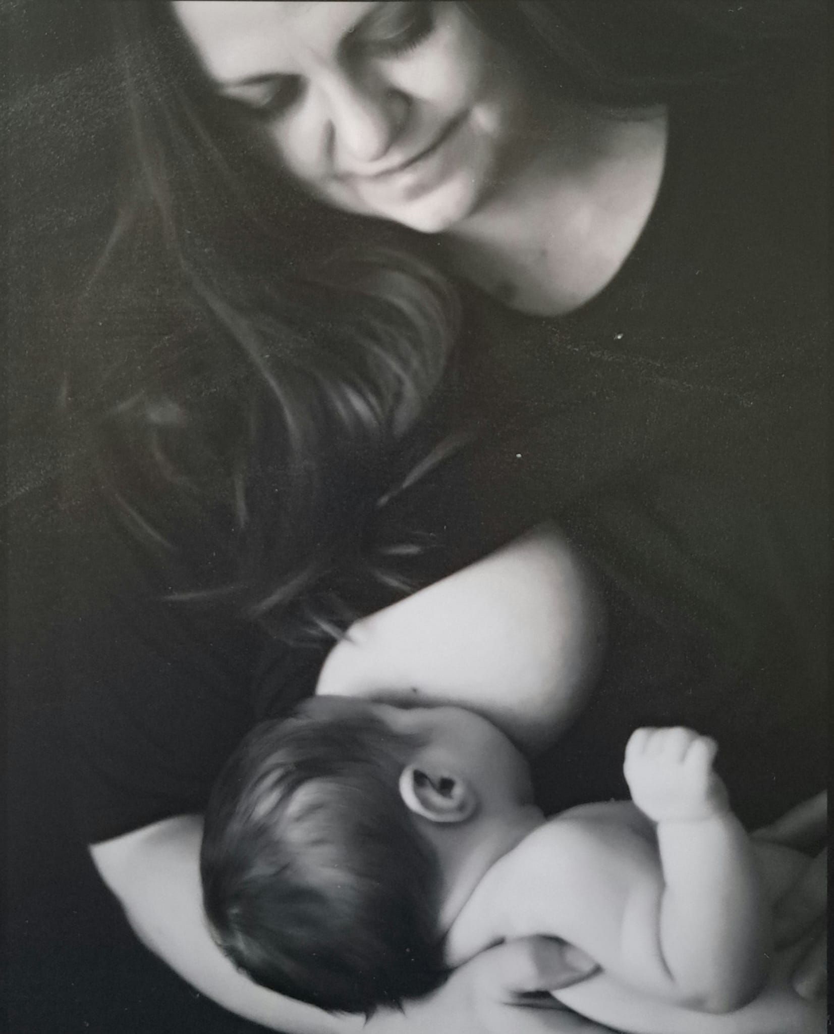 Joanna smiling down at her newborn baby